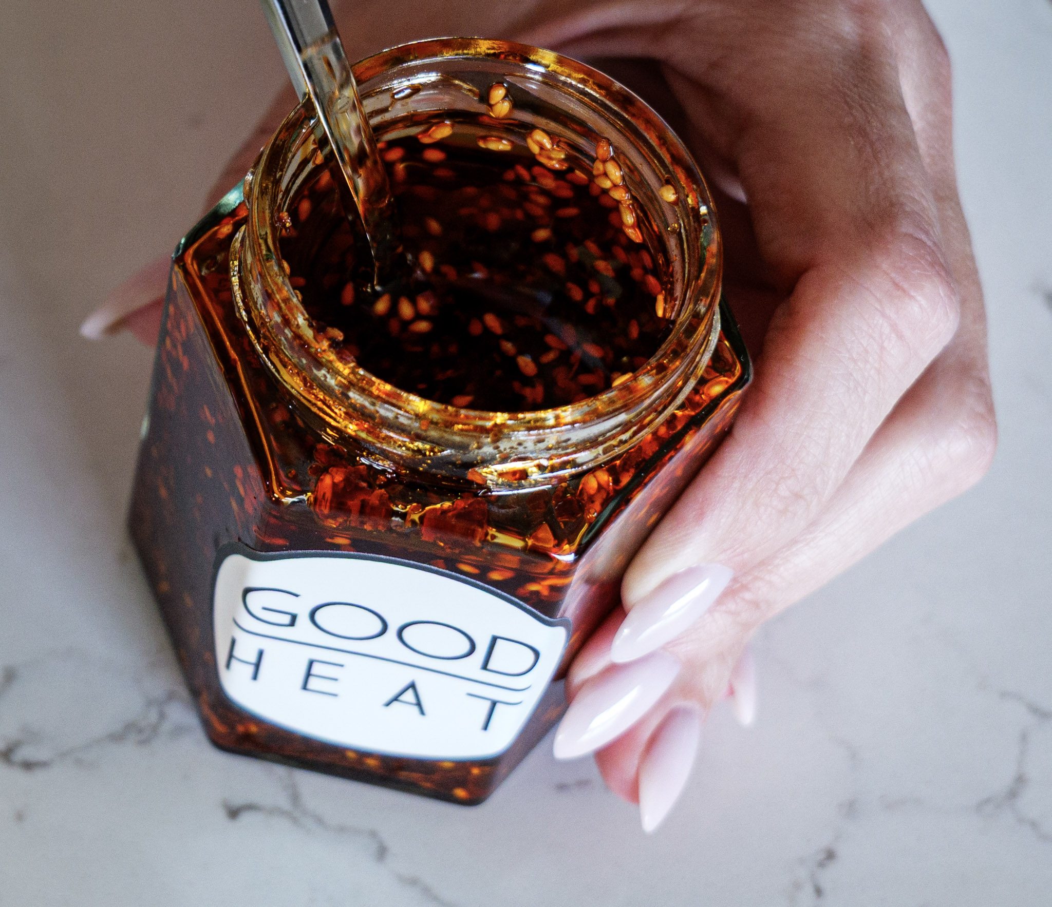 Good Heat Hot Chili Oil — a jar of rich, deep-red chili oil with toasted flakes and sesame seeds